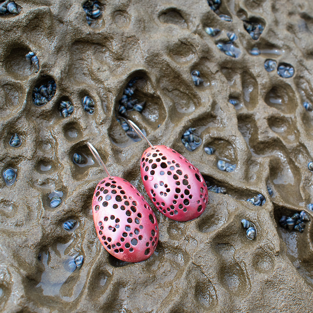 Spiral Hole Earrings Copper on tidal rock