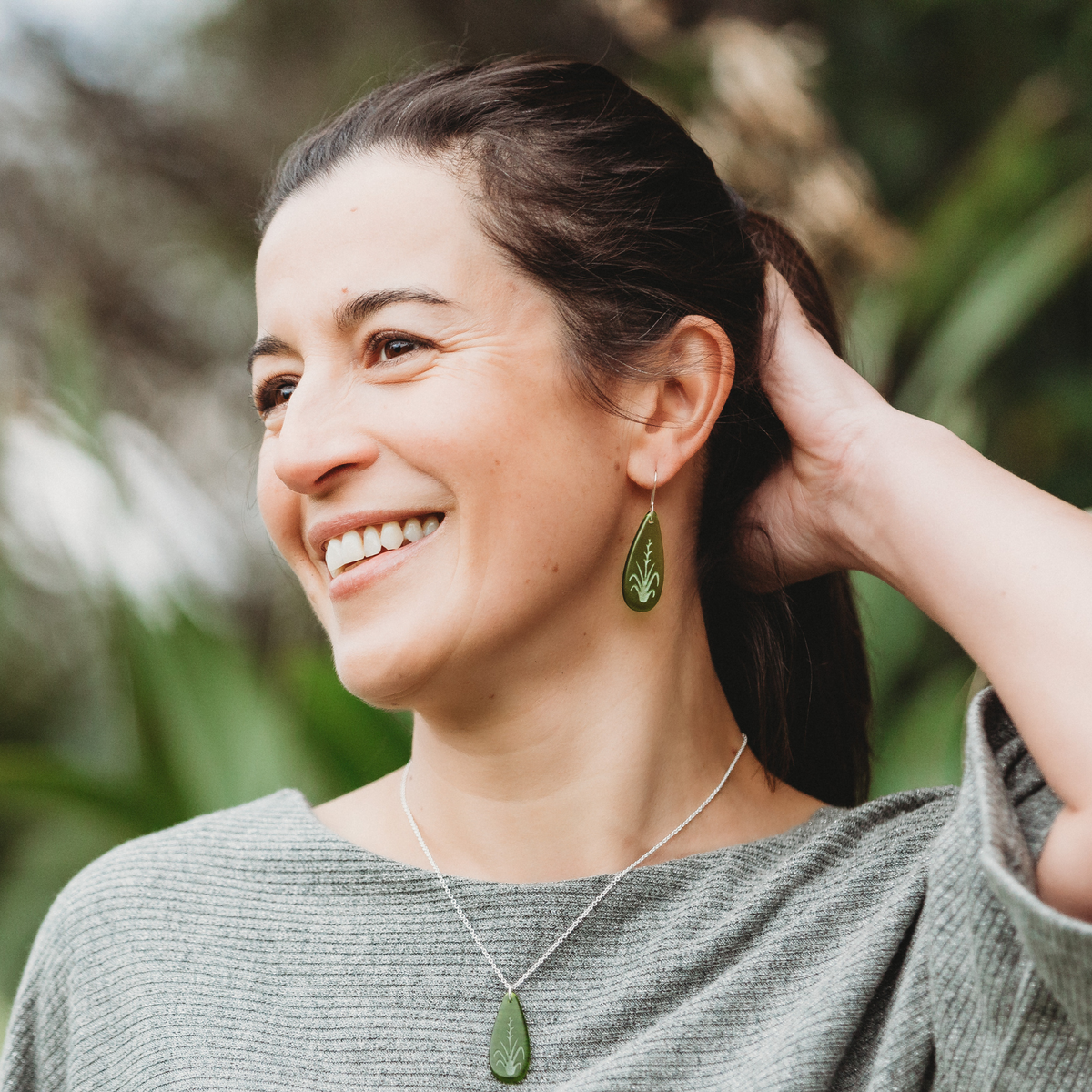 Harakeke Earrings Green worn on model with matching necklace