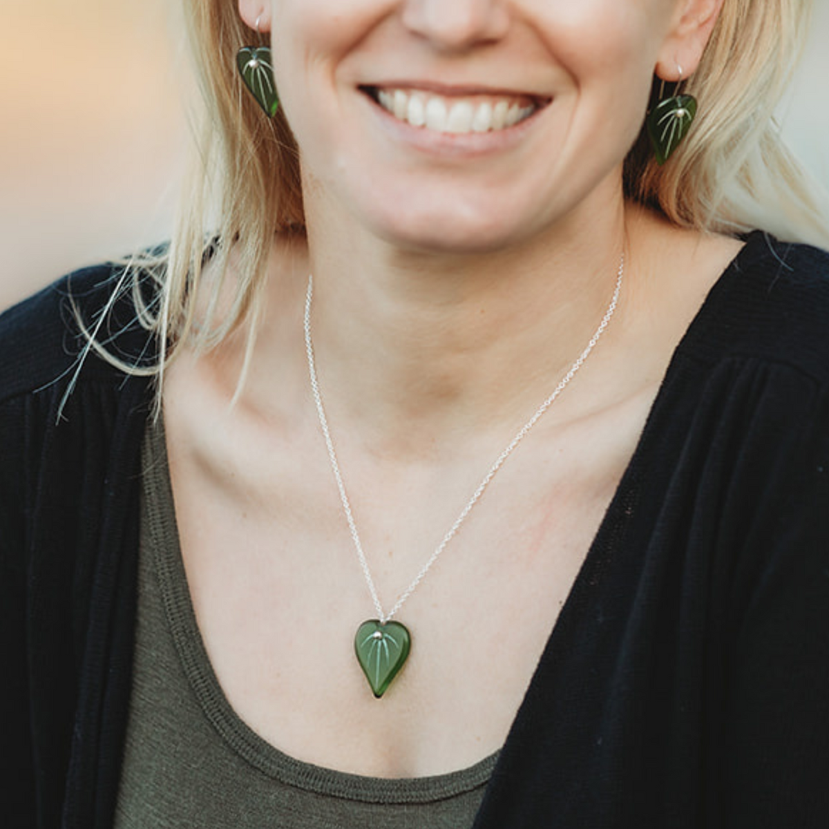 Kawakawa Leaf Pendant and Earrings Green worn on model