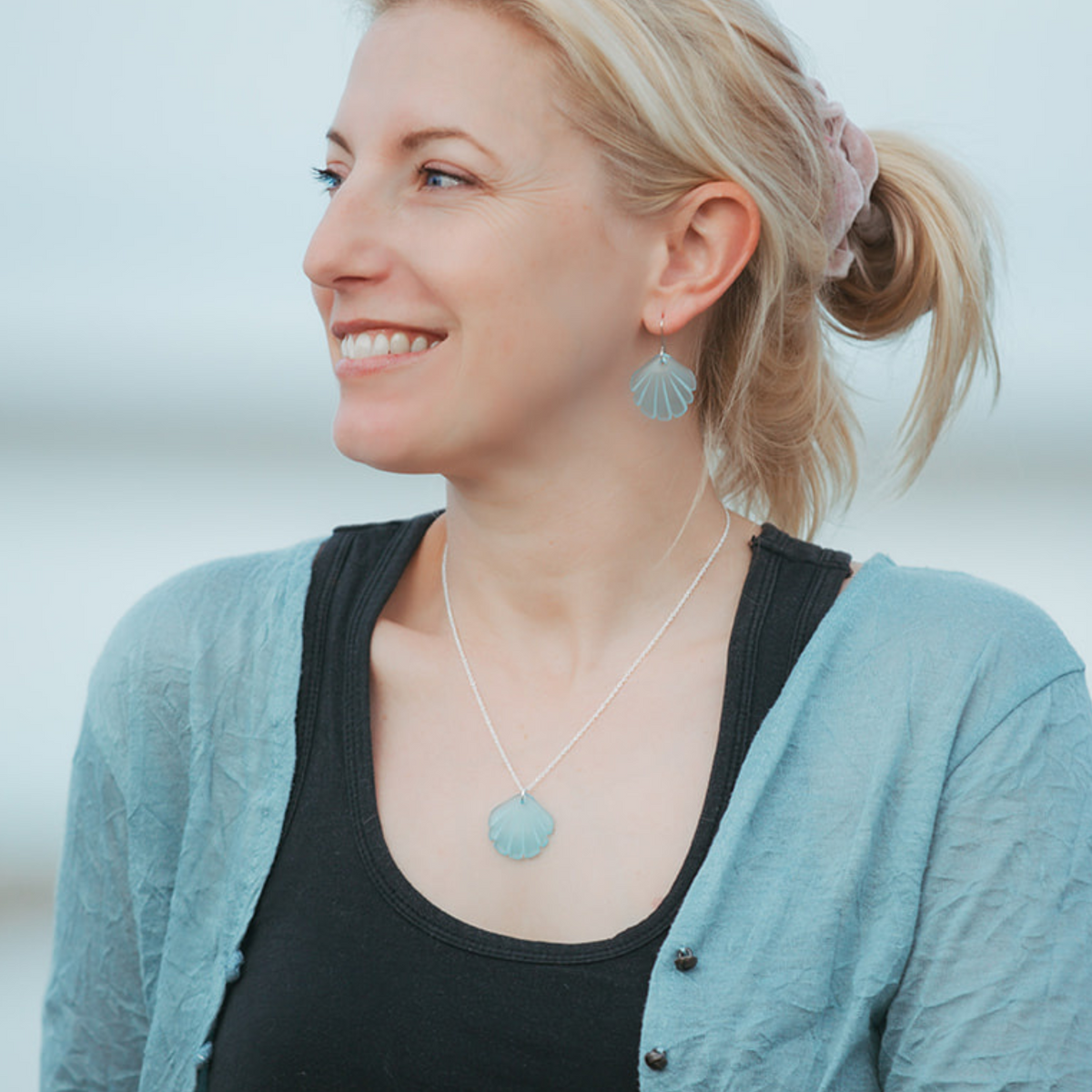 Scallop Shell Pendant and Earrings Light Blue worn on model