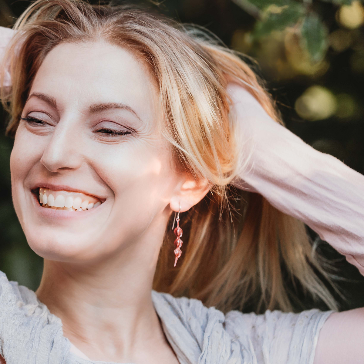 Copper Kōwhai Pod Earrings on model