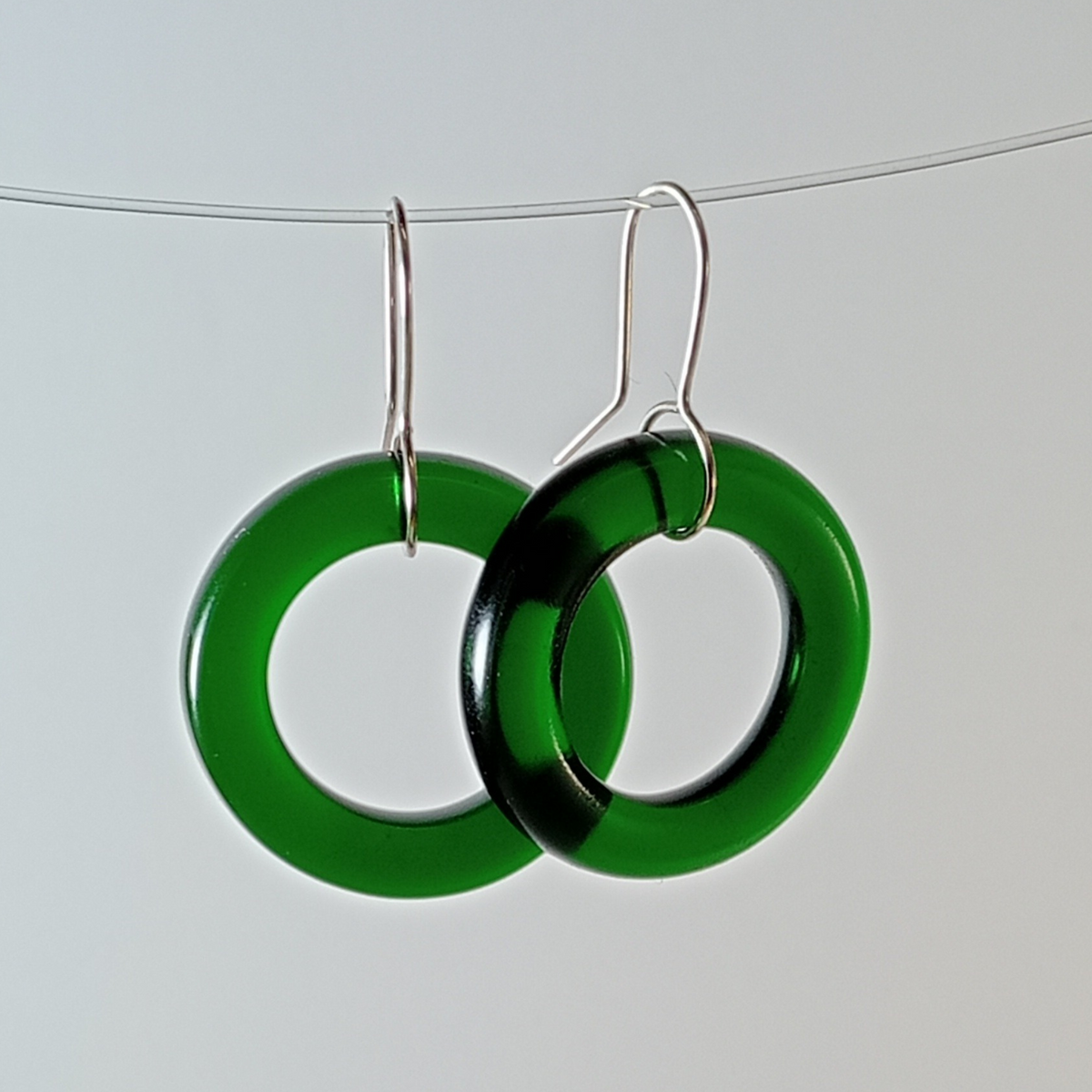 Emerald Hoop Earrings illuminated with light