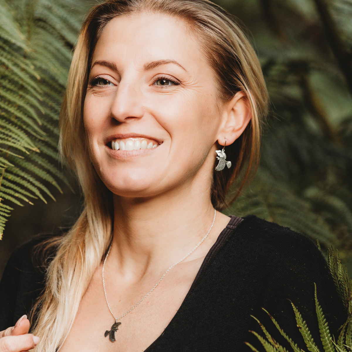 Tūī Pendant and Earrings on model