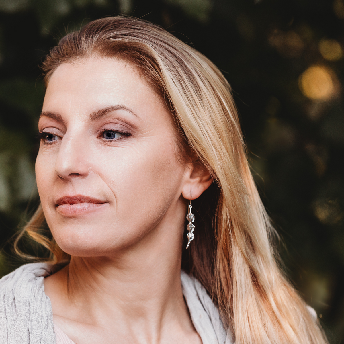 Silver Kowhai Pod Earrings on model