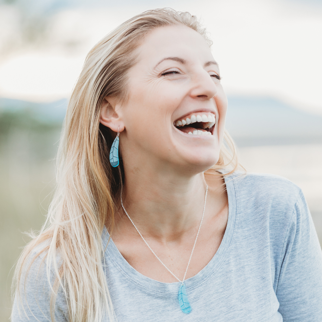 Huia Feather Pendant and Earrings Light Blue on model