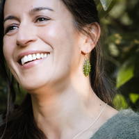 Close up of Pukatea Leaf Earrings worn on model