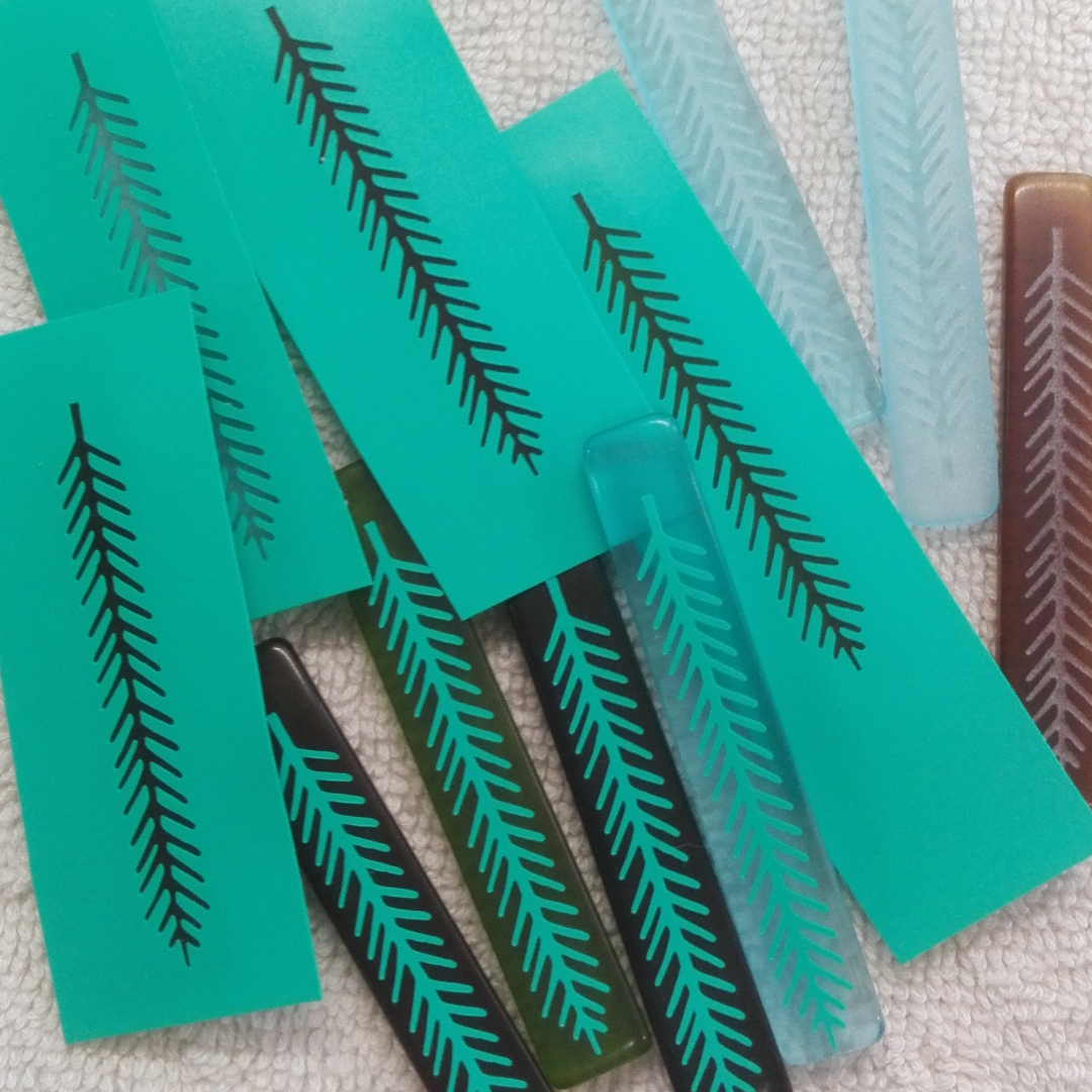 Rimu Leaf Drop Earrings in progress showing stencils for sandblasting