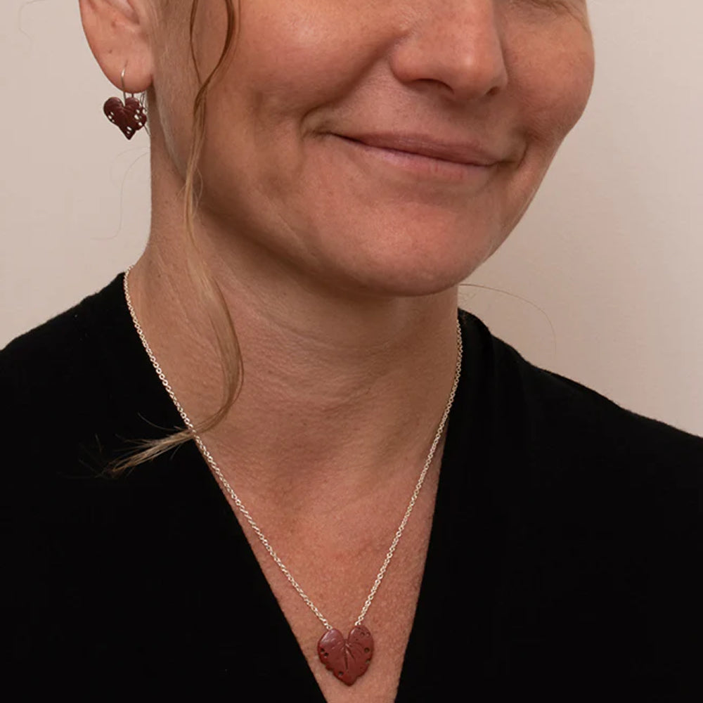 Kawakawa Pendant Copper worn on model with matching earrings