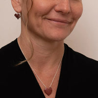 Kawakawa Pendant Copper worn on model with matching earrings